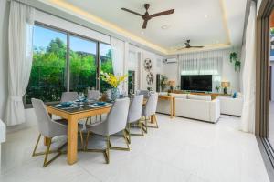 a dining room with a table and chairs at Villa Mimosa 1, Splendid 4 Bedroom Master Ensuite in Phuket Town
