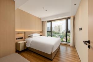 Katil atau katil-katil dalam bilik di Jiangmen Poltton Executive Service Apartment