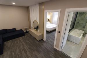 a room with a couch and a bathroom with a tub at ONKA OTELCİLİK TURİZM TİCARET LİMİTED ŞİRKETi in Istanbul +23 photos