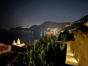a view of a city at night at Wonderhome Praiano in Praiano