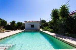 a swimming pool in front of a house at INNOUTHOME Chalet familiar con piscina privada numero u in L'Ametlla de Mar