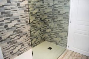 a shower with a glass door and a tile wall at Maison de charme 3 étoiles avec jardin clos terrasse PERROS-GUIREC - ref 869 in Perros-Guirec +18 photos