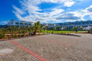 a brick walkway in front of a large building at Deja Blue Apartment Cyprus in Bahçeli +6 photos