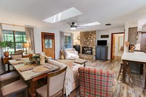 a living room with a table and a living room with a fireplace at Avail This Weekend, Lakefront, Kayaks, Fenced in Shreveport