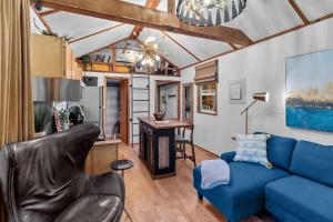 a living room with a blue couch and a table at Lakefront Tiny Emerald Wkayaks & Canoes in Shreveport