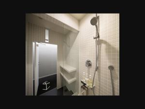 a bathroom with a shower with a glass door at 9h nine hours Narita Airport in Narita