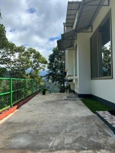 a balcony of a house with a view at Willow Nest in Anachal