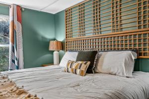 a bedroom with a large bed with a wooden headboard at Chic Cypress View Cabin Wkayaks & Canoes in Karnack