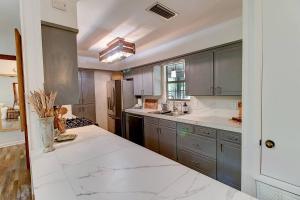 a large kitchen with gray cabinets and white counter tops at Avail This Weekend, Lakefront, Kayaks, Fenced in Shreveport +61 photos