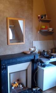 a living room with a fireplace and a mirror at Backpacker room with an Eiffel Tower view near St Germain des Prés in Paris