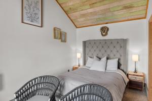 a bedroom with a large bed with two chairs at 2 Mi To Casinos, Red River Lodge, River Views in Shreveport