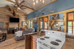 a kitchen with a stove and a living room at 2 Mi To Casinos, Red River Lodge, River Views in Shreveport +62 photos