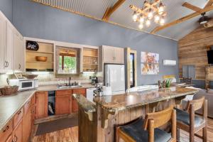 a large kitchen with wooden cabinets and a large island at 2 Mi To Casinos, Red River Lodge, River Views in Shreveport