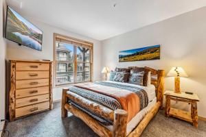a bedroom with a bed and a window at Breckenridge Condo: Large Patio & Shared Amenities in Breckenridge