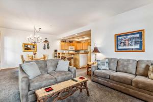 a living room with two couches and a table at Breckenridge Condo: Large Patio & Shared Amenities in Breckenridge
