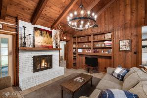 a living room with a fireplace and a couch at Canoes, Firepit, Outdoor Dining, Cedar Lodge in Karnack