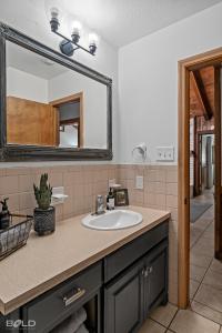 a bathroom with a sink and a mirror at Cedar Wood Lodge Wkayaks & Canoes, Outdoor Dining in Karnack +69 photos