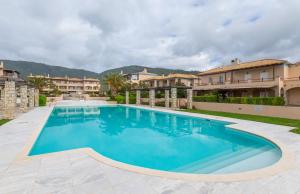 a swimming pool in a villa with blue water at Villa Blu Mare in Nafpaktos