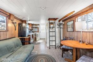a living room with a couch and a table at Shipwreck with upper deck, Dock Access, Kayaks in Karnack
