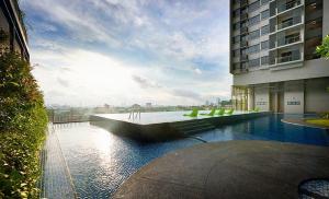 a building with a pool of water next to a building at Sky Pool Luxury Suite in Kuala Lumpur +12 photos