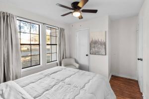 a bedroom with a bed and a ceiling fan at Southern Magnolia House With Porch Swing in Mooringsport