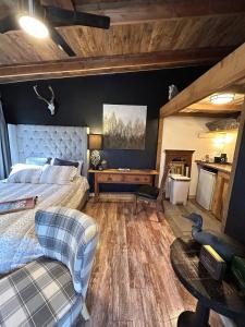 a bedroom with a bed and a couch and a table at River View, Red River Carriage House in Shreveport