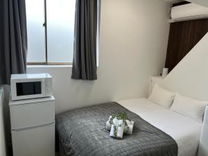 Ένα ή περισσότερα κρεβάτια σε δωμάτιο στο Ikebukuro Area R1 NishiikeApartment 5F No Elevator