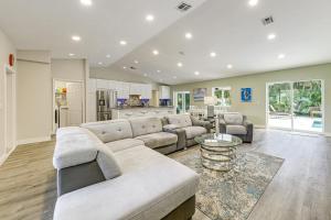 a large living room with a couch and a table at 2 Mi to Deerfield Beach Home with Outdoor Oasis! in Deerfield Beach
