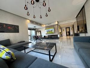 a living room with a couch and a table at Sweet Jacob's Appartment Gueliz City Center in Marrakesh +216 photos