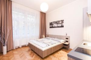 Łóżko lub łóżka w pokoju w obiekcie Manesova Astra Apartment