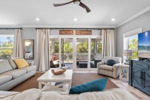a living room with a couch and a tv at Heron's Crossing at Lost Key Golf & Beach Club in Pensacola