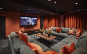 a living room with a couch and a tv at The Regency By Birch Stays in Chester