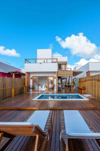 a house with a deck and a swimming pool at Bahia Soul - Lake House - Barra Grande - Península de Maraú in Barra Grande