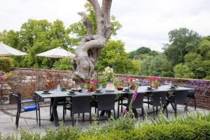 a table set up for a meal under a tree at The Regency By Birch Stays in Chester
