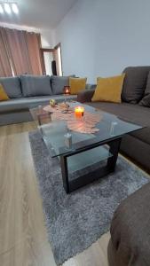 a living room with a couch and a glass table at Ultra Central and Spacious with AC and Balcony in Iaşi