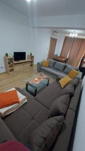a living room with a couch and a table at Ultra Central and Spacious with AC and Balcony in Iaşi