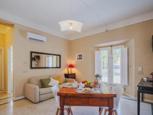 a living room with a table and a couch at Marilla Apartment in Capannori
