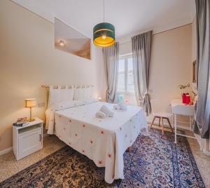 a bedroom with a bed and a table and a chair at Marilla Apartment in Capannori