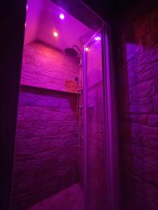 a purple light in a room with a brick wall at La Trinacria casa vacanze in Bronte