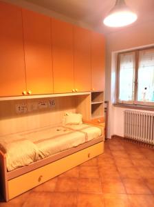 a bedroom with a bed and cabinets and a window at Al Parchino in Arezzo
