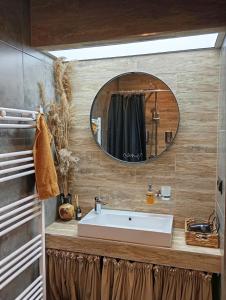 a bathroom with a sink and a mirror at City center Artmania apartments in Chişinău
