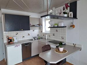 a kitchen with a table and a counter top at Ferienwohnung direkt am See 2 in Altmünster