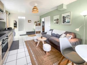 a living room with a couch and a table at Vue Montagne à Saint Martin d'Hères in Saint-Martin-dʼHères