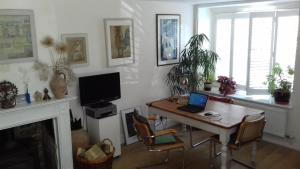 a living room with a table with a laptop on it at 38 Newtown in Bradford on Avon