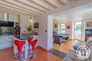 a kitchen and living room with a pool table at La coudraie votre maison de vacances en famille in Daumeray