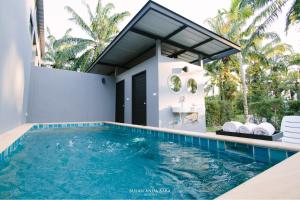a swimming pool in the backyard of a house at Bulan Anda Resort in Ban Hua Laem