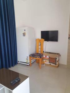 a living room with a refrigerator and a chair at Villa Omar El Sharif Appartement studio n2 in Luxor +15 photos