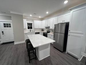 a kitchen with white cabinets and a white counter top at Charming Gainesville Townhome 2 in Gainesville