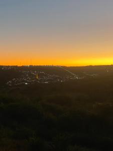 a sunset view of a city at dusk at Casa Temporada Oasis no Sertão in Triunfo