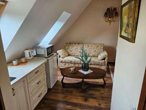 a living room with a couch and a coffee table at Vila Mažoji apartamentai in Palanga